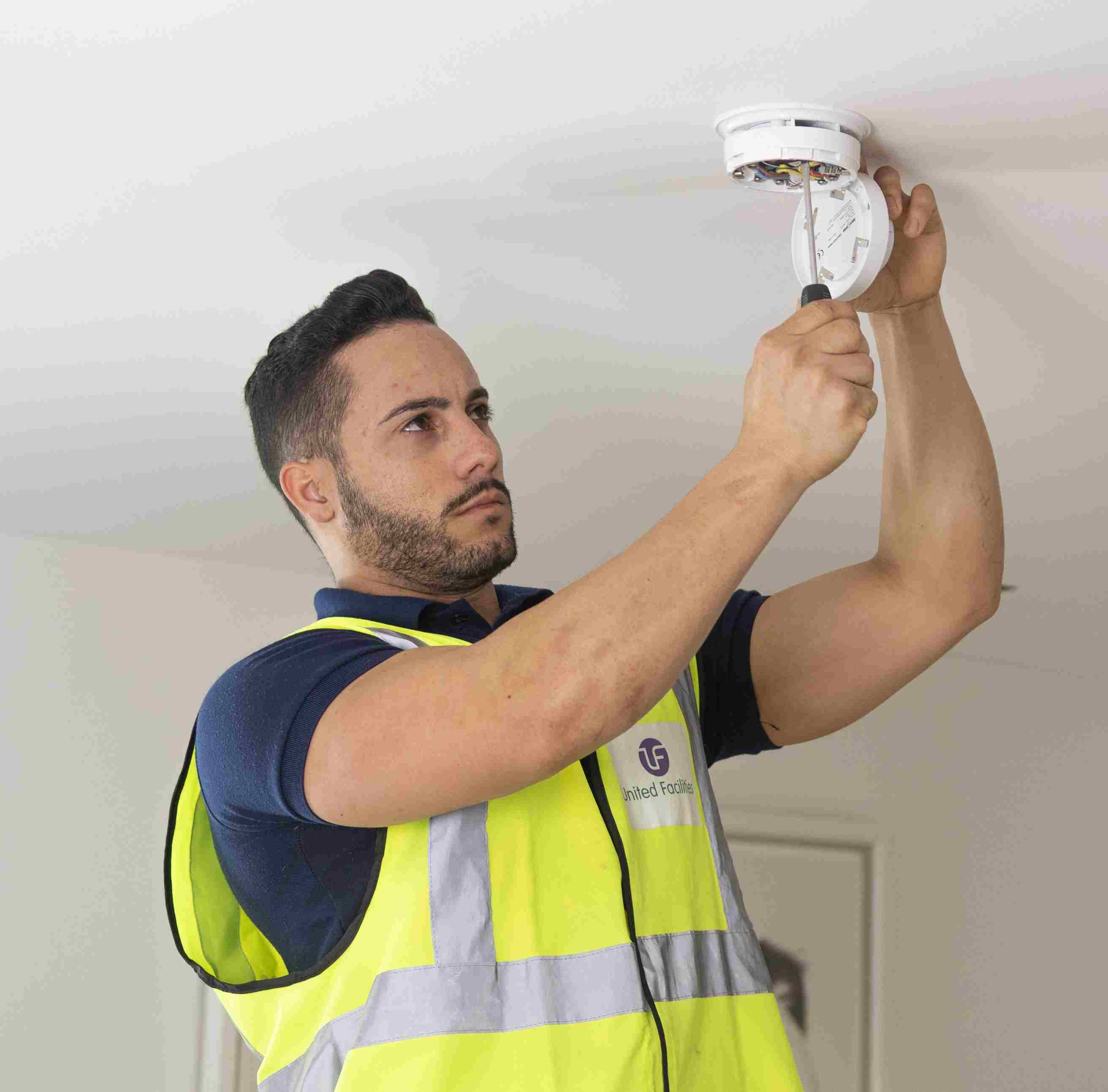 A facilities professional completing commercial property maintenance